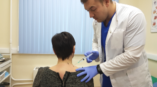 The doctor gives injections into the neck